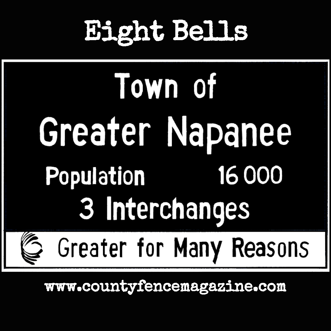 Title card for article: Eight Bells featuring a drawing of the Napanee highway sign. Reads “Town of Greater Napanee, Population 16,000, 3 Interchanges. Greater for many reasons.”